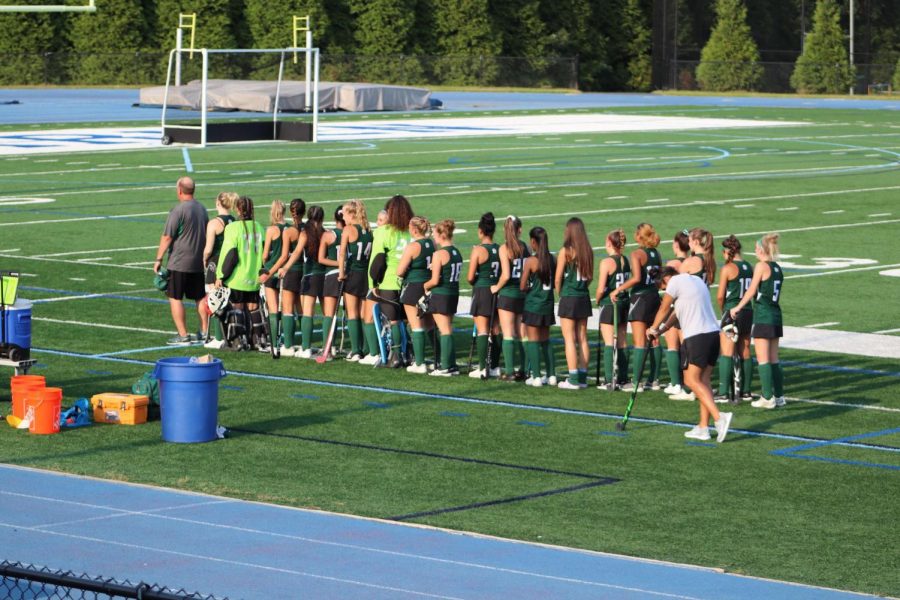 Girls Field Hockey lining up for the National Anthem. 