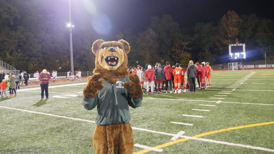 Mr. Bear takes a picture with the Greenwich soccer team after the game.