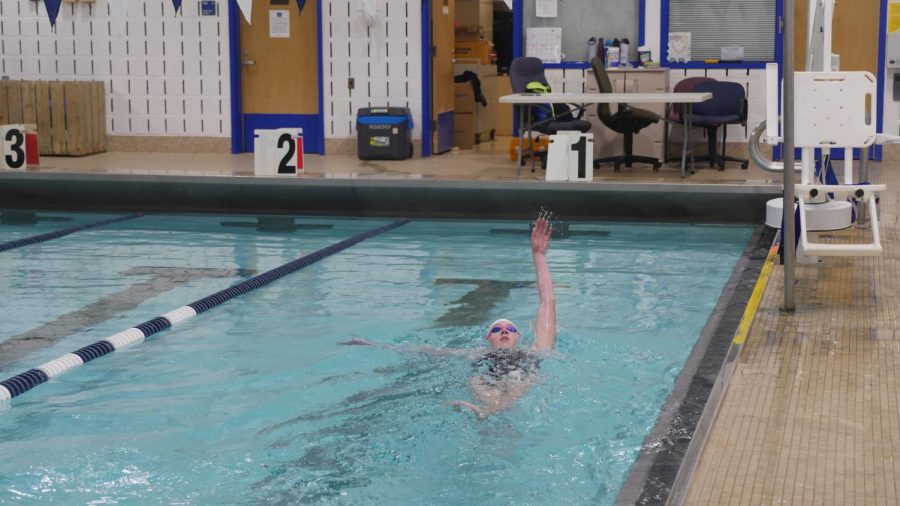 Freshman Chloe Abelman swimming Backstroke.