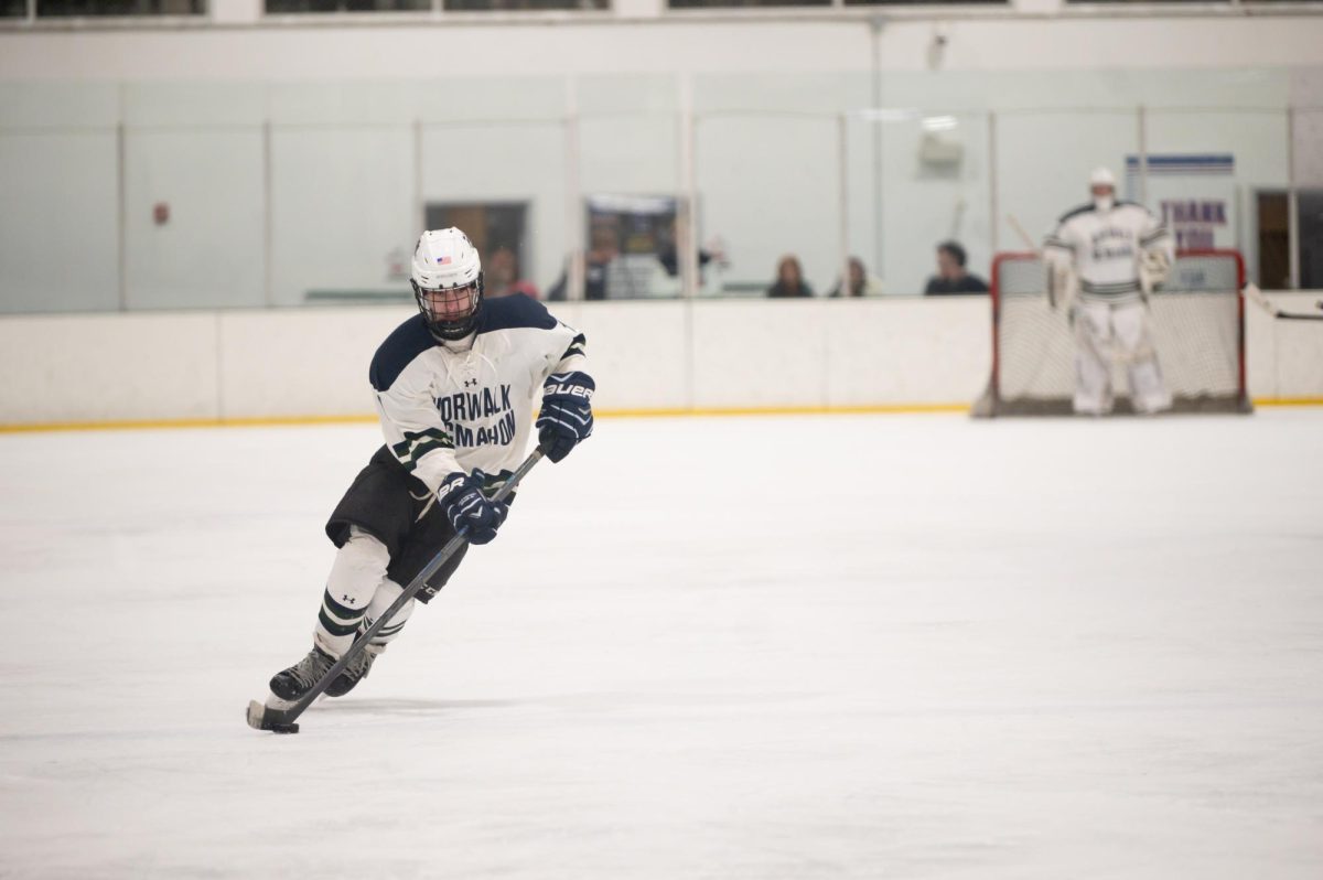 Tyler Camiglio skating down the ice with the puck