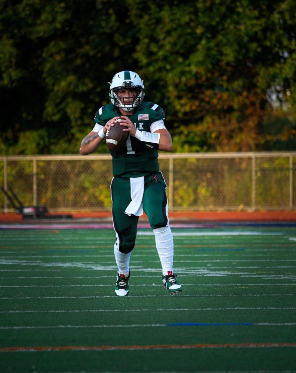 Quarterback Mason Riina warming up for before game