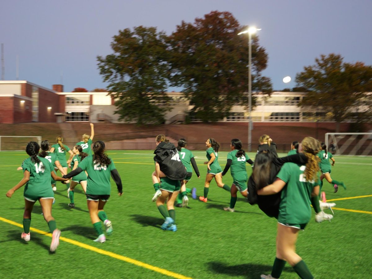 Girls Soccer running on the field after getting their first win of the season