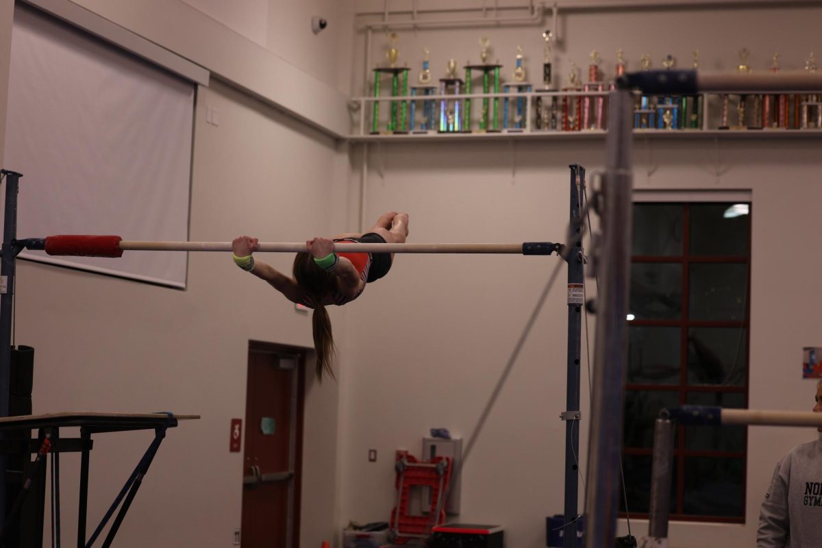 Sargeant practicing her bars routine 