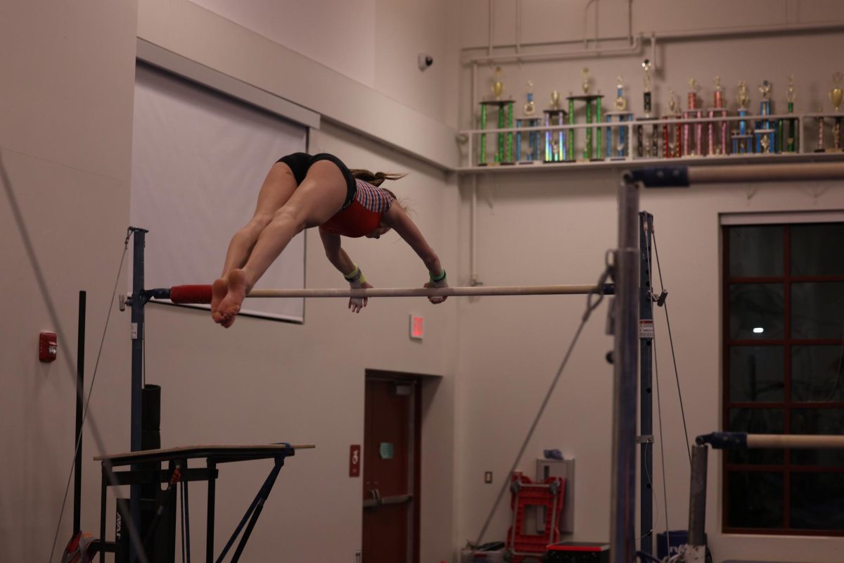 Sargeant practicing her bars routine 